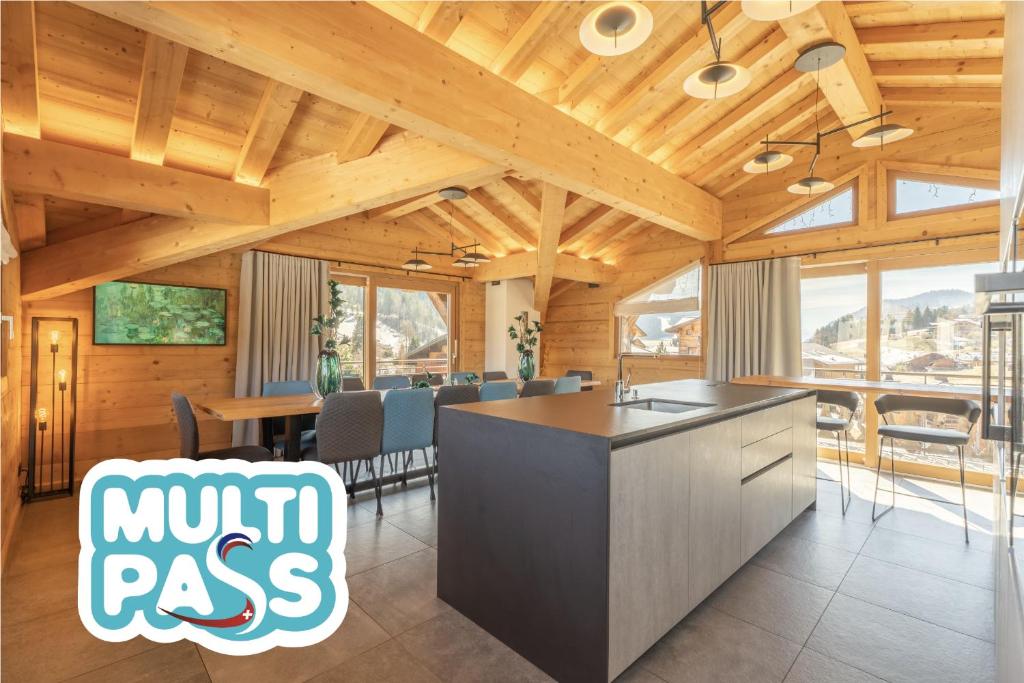 a kitchen and dining room with wooden ceilings at Hameau des clos Téléporté in Les Gets