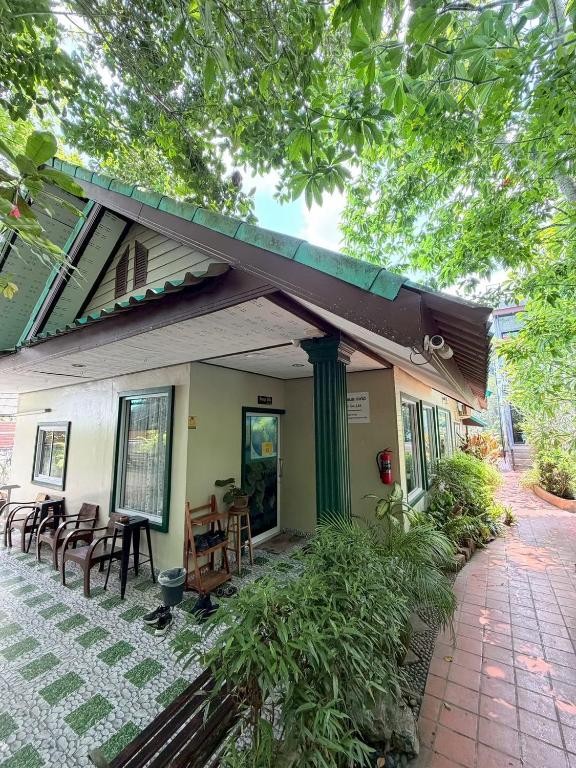 a house with a porch with chairs and a patio at Areeya Phubeach Resort Coliving Coworking in Ao Nang Beach