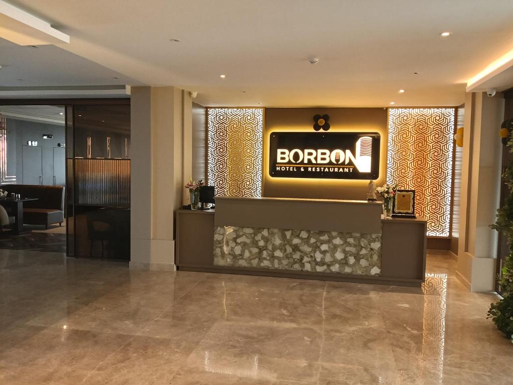 a lobby with a bordo sign in a building at Borbon Hotel & Restaurant in Jowai