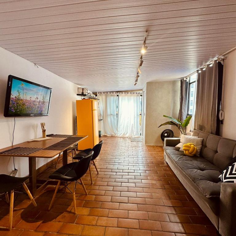 a living room with a couch and a table at Cobertura Mangabeiras com vista incrível de BH e área gourmet in Belo Horizonte