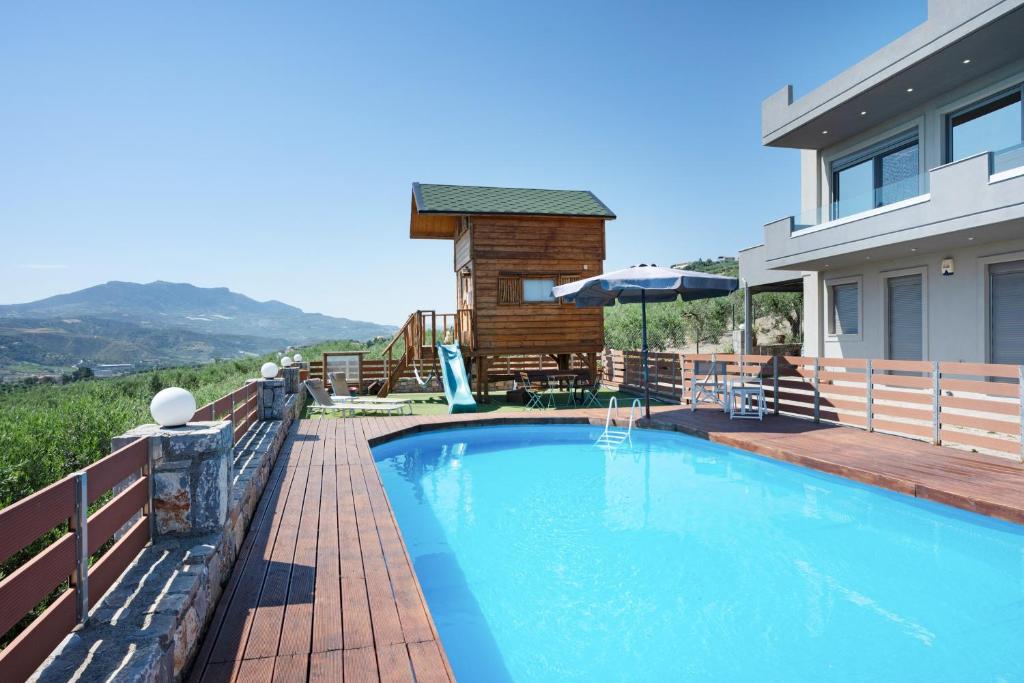 a swimming pool in front of a house at Peaceful house in Goúrnes