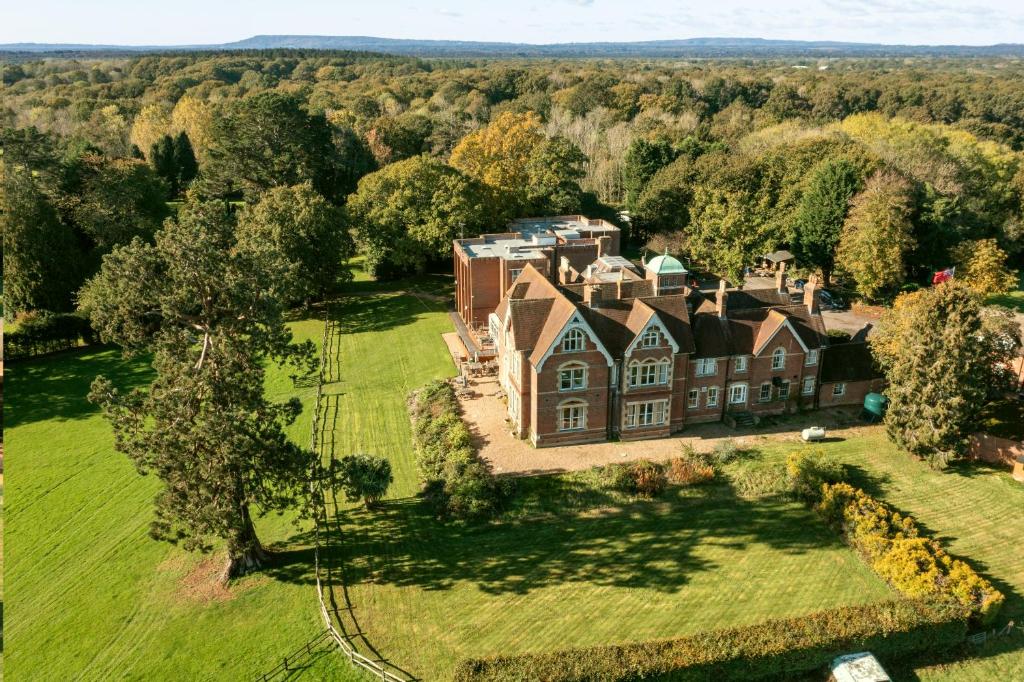 an aerial view of a large house on a green field at Care Ashore Guest Rooms in Cranleigh