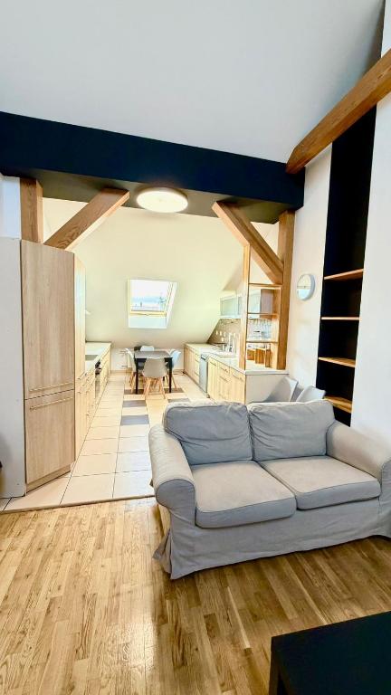 a living room with a couch and a kitchen at Rynek 30 in Leżajsk