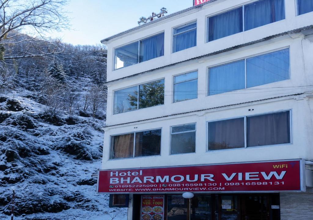 a building with a sign that reads hotel birmingham view at Hotel Bharmour View in Brāhmaur