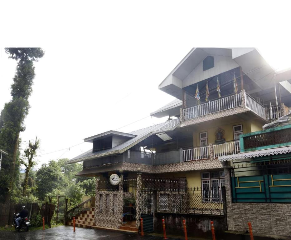 a building with a clock on the side of it at Ang Ds Homestay in Sonāda