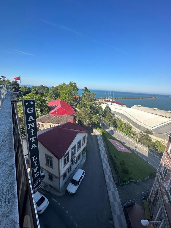 a building with cars parked in a parking lot at Ganita Life Hotel in Trabzon