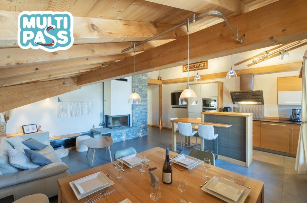 a living room with a couch and a table at Appartement Corniche - MultiPass in Les Gets