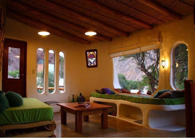 a living room with a couch and a table at Cabañas Azul Andino in Purmamarca