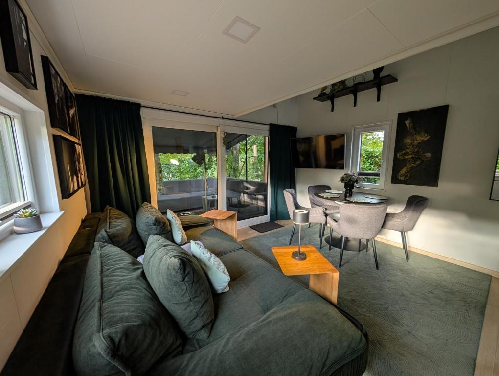 a living room with a couch and a table at Tinyhouse Nelson in Papenburg