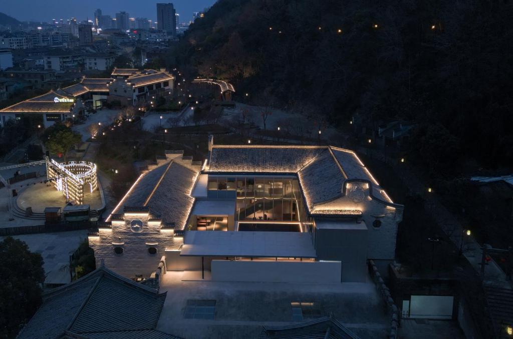 a building with lights on top of it at night at Hayama Pagoda Villa in Taizhou