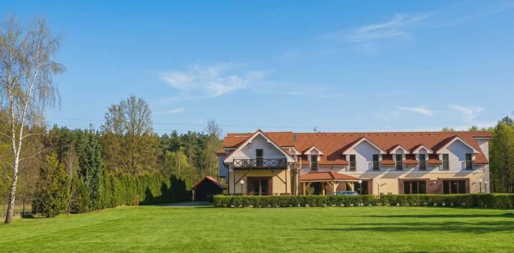 a large house with a green lawn in front of it at Biovilla in Stobnicko