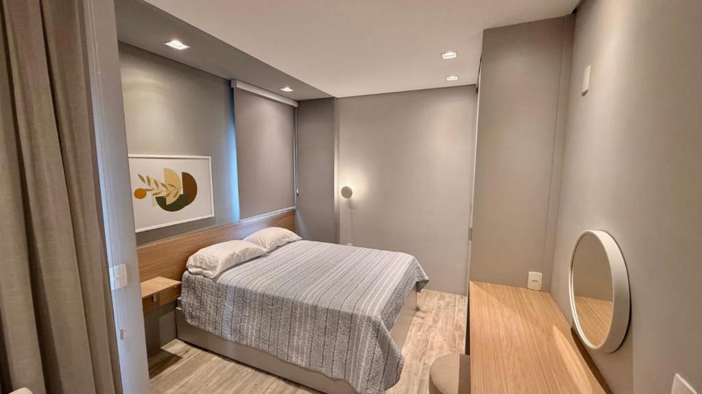 a small bedroom with a bed and a mirror at Today Perdizes São Paulo - Allianz Parque in São Paulo