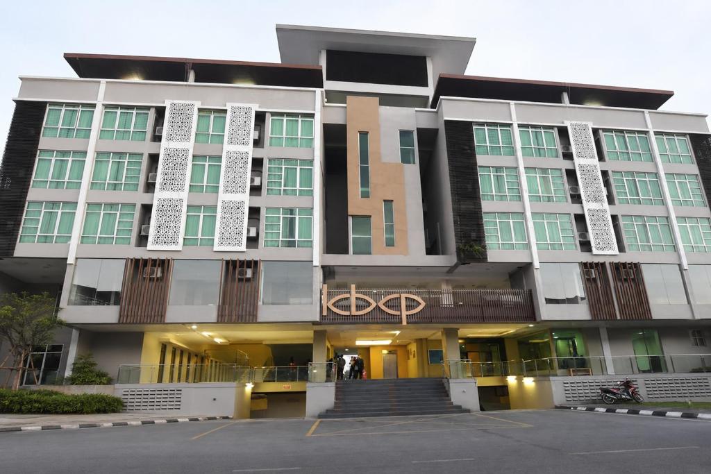 a large building with a staircase in front of it at Ain Studio Apartment in Kota Bharu
