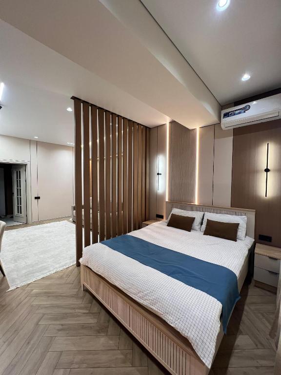 a bedroom with a large bed in a room at Eleon apartment in Bishkek
