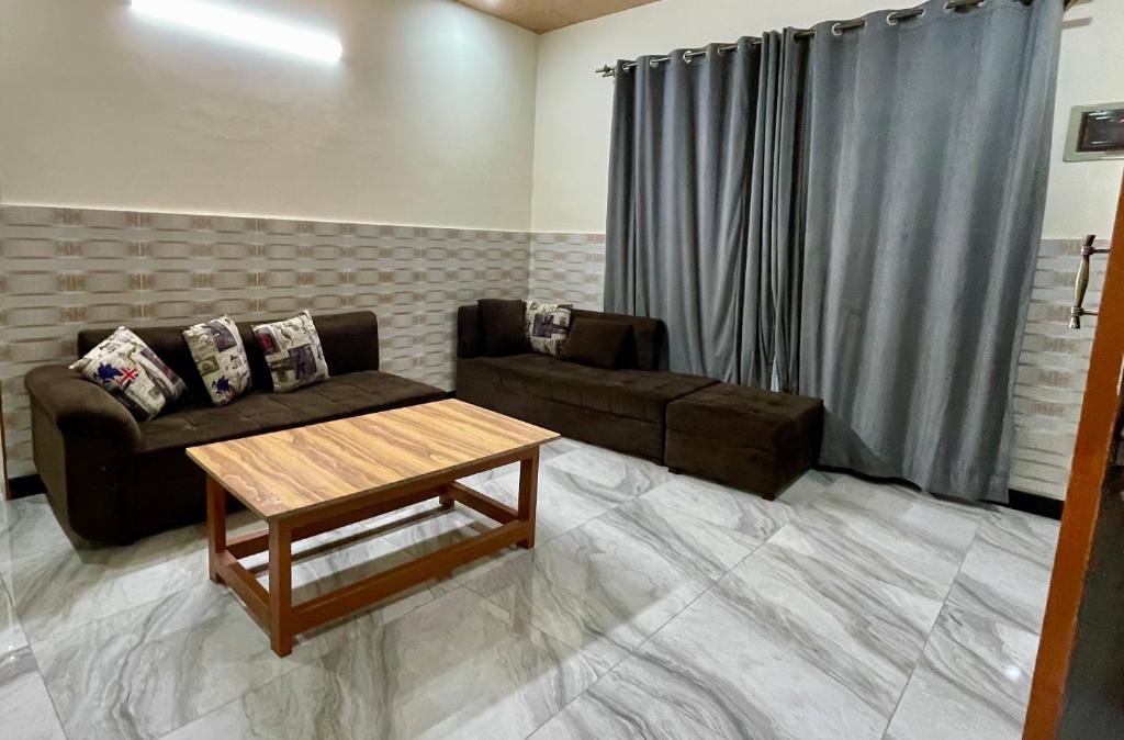 a living room with a couch and a coffee table at 1 Bed Apartment with View in Patriata