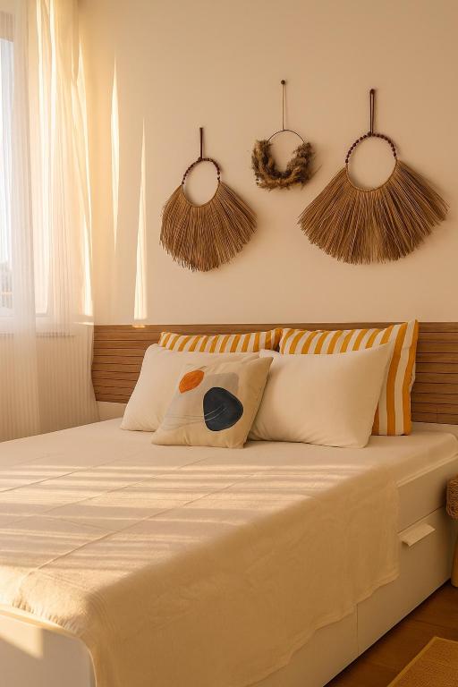 a bedroom with a bed with pillows on it at Panorama Sunset Studio in Stara Zagora