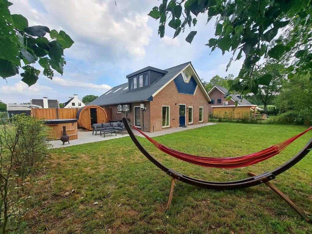 a hammock in the yard of a house at Erve Lindehof in Lochem
