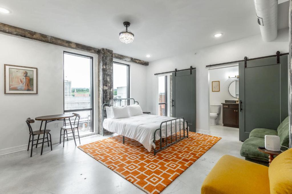 a bedroom with a bed and a table and chairs at Park Hotel Studio Suite 507 in Chattanooga