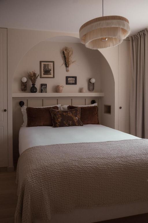 a bedroom with a large bed with a white bedspread at Apparts Rennes BnB Duhamel in Rennes