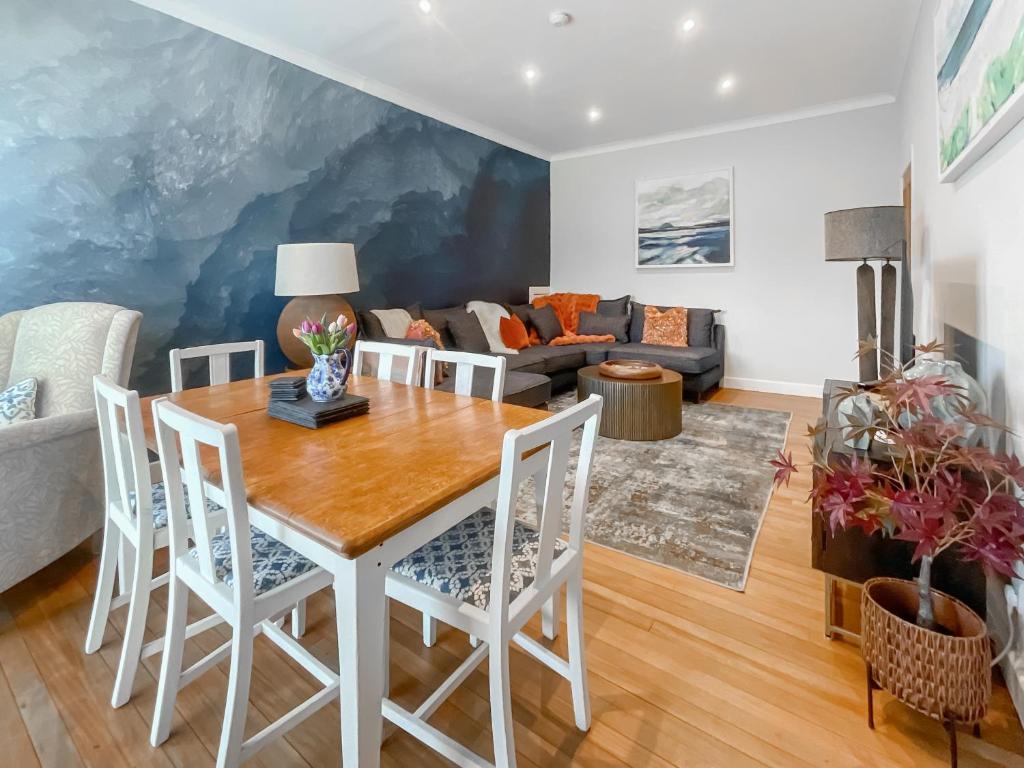 a living room with a table and chairs and a couch at Taigh Beag in Stranraer
