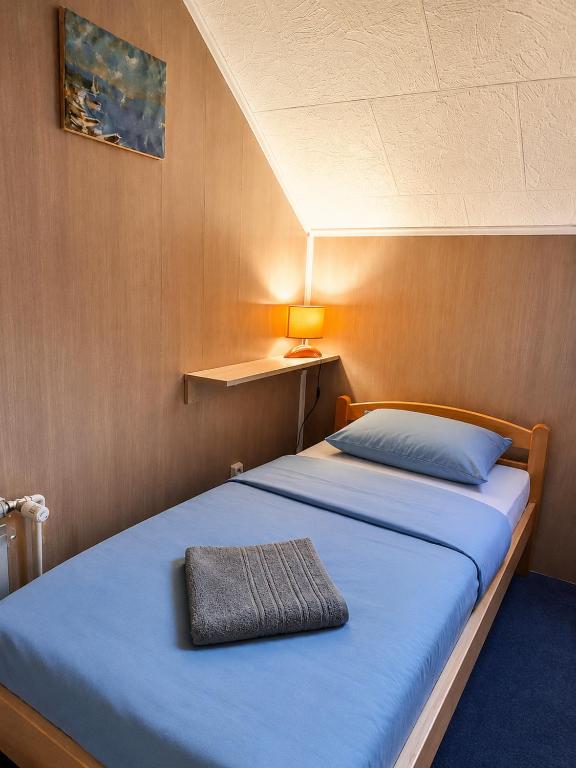 a bedroom with a bed with a pillow on it at Hostel Suzzzy in Novska