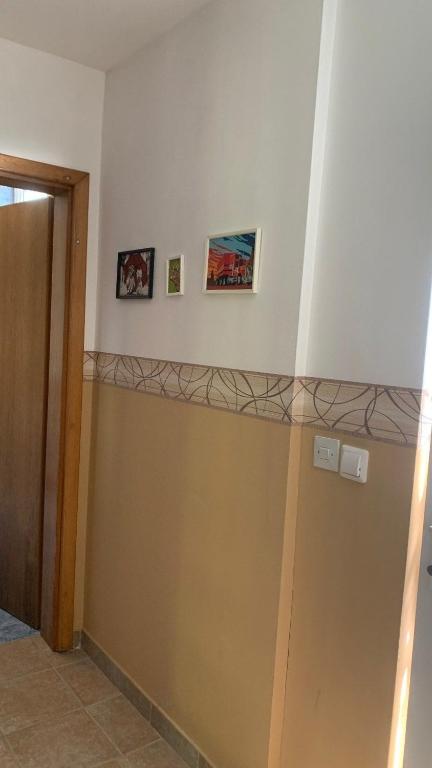 a hallway with a wall with two pictures on it at Apartman Dream in Foča