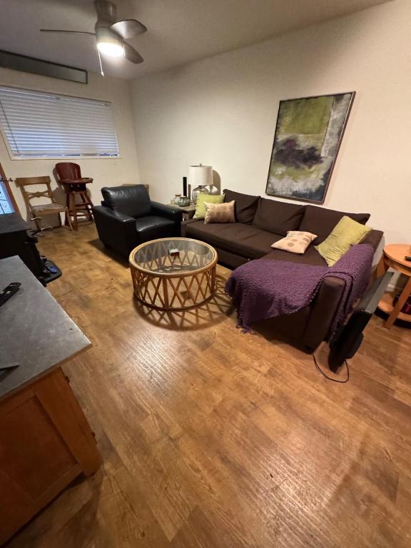 a living room with a couch and a table at Home near the redwoods in Fort Bragg