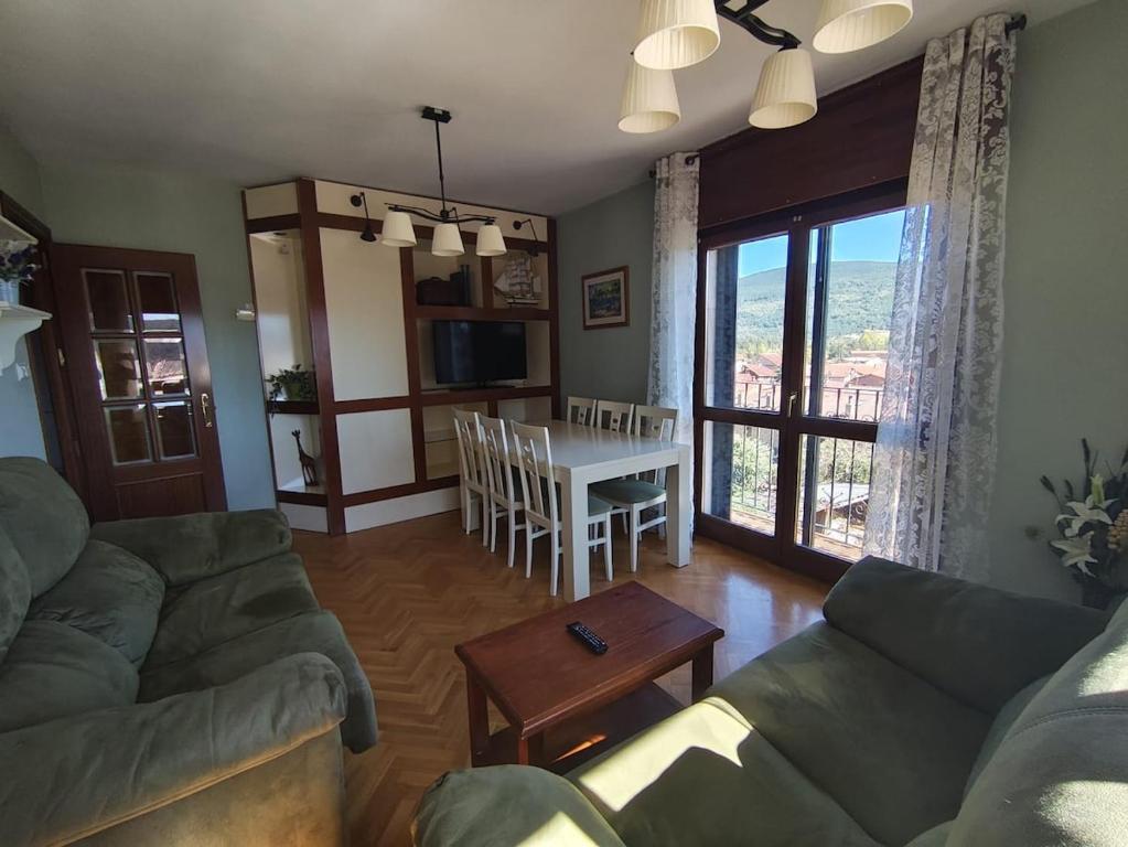 a living room with a couch and a table at La Royana in Vinuesa