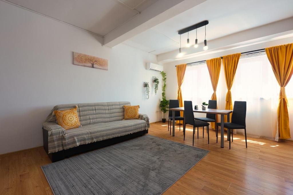 a living room with a couch and a table at Old Town Smârdan Apartment - Central Lively Area in Bucharest