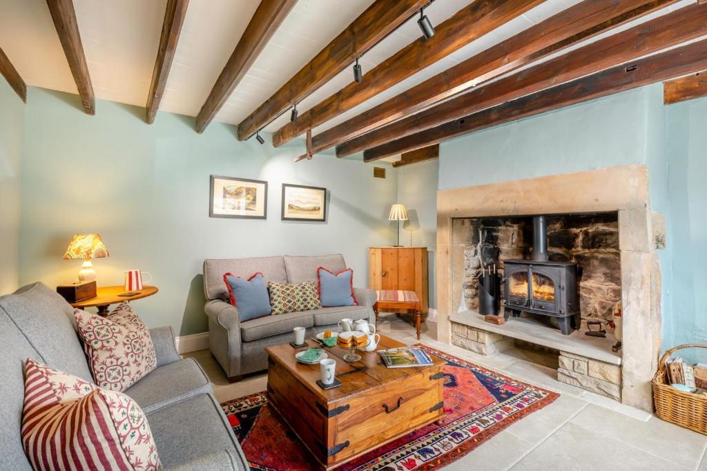 a living room with a couch and a fireplace at 3 Bed in Morpeth oc-75083 in Harbottle