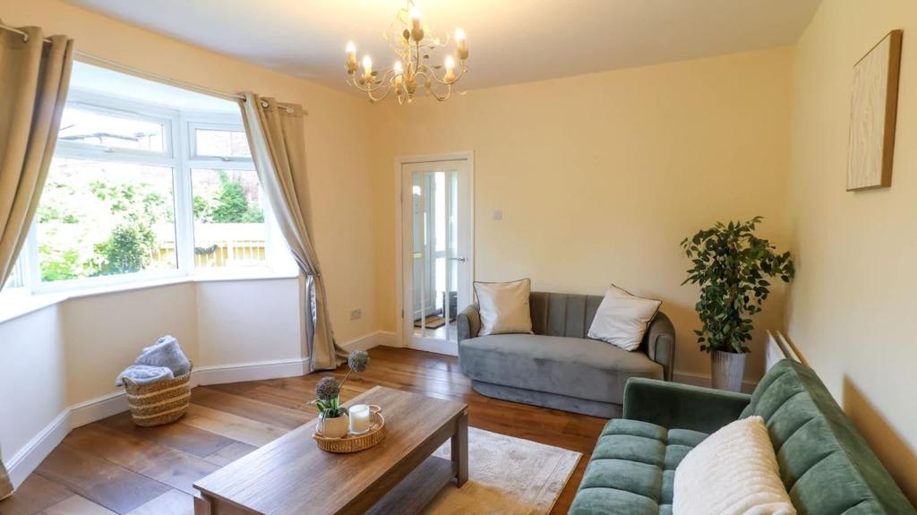 a living room with a couch and a table at Spacious and Modern Durham home in Gilesgate