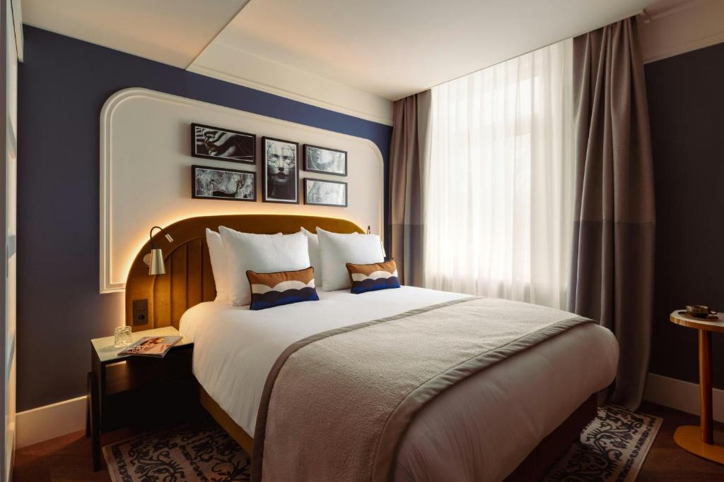 a hotel room with a large bed and a window at Leonardo Boutique Hotel The Lancaster Amsterdam in Amsterdam