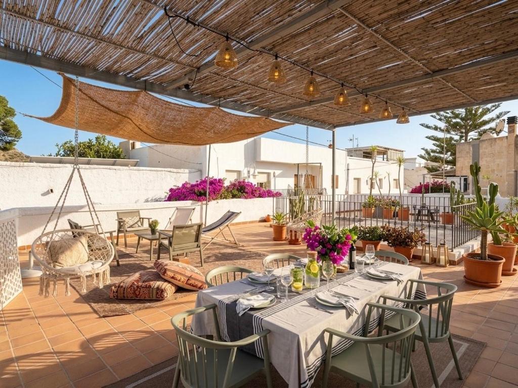 an outdoor patio with a table and chairs at Casita Pablo in Agua Amarga