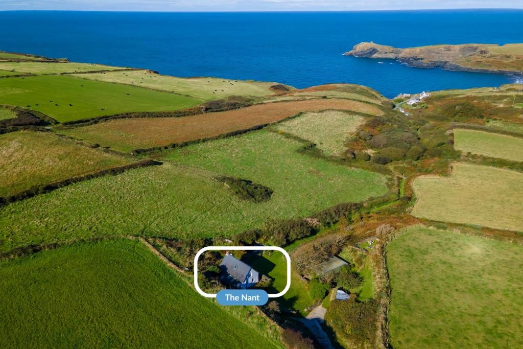 an aerial view of a house on a hill next to the ocean at The Nant in Haverfordwest