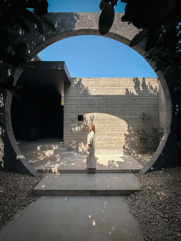 a person standing in front of a brick wall at 陽月-Hizuki- in Nakijin