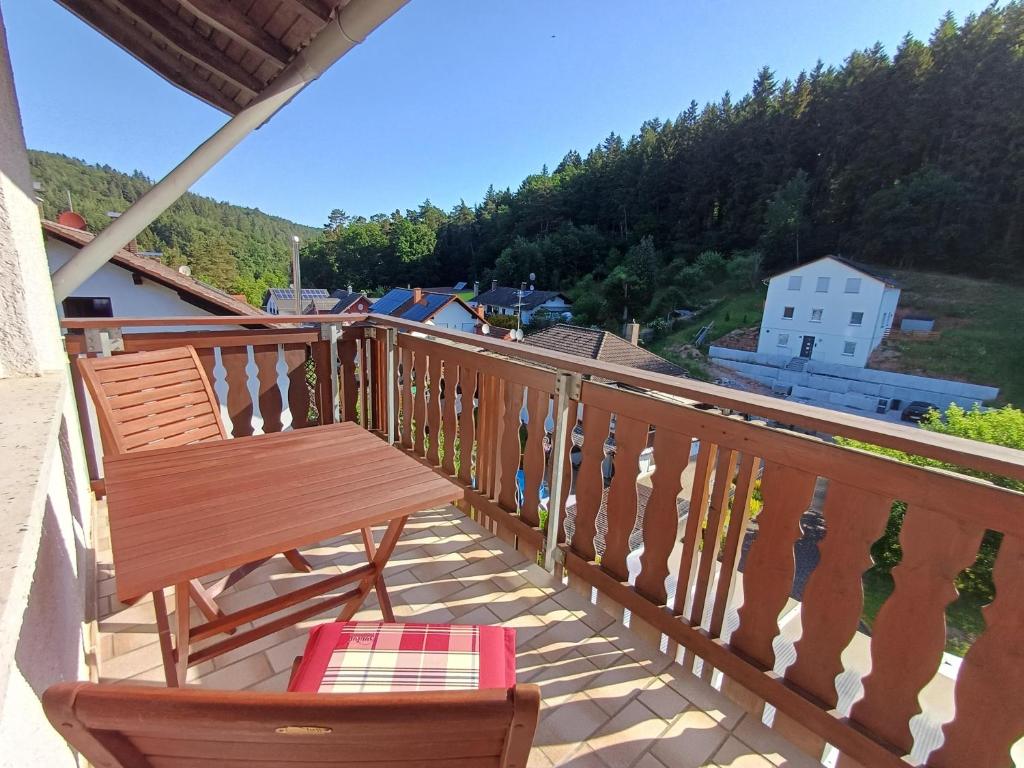 a wooden balcony with a bench and a view at Adelheids Apartment in Lützelbach