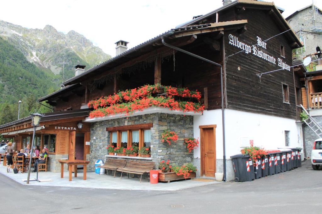 a building with flowers on the front of it at Albergo Alpino Cheggio in Alpe Cheggio