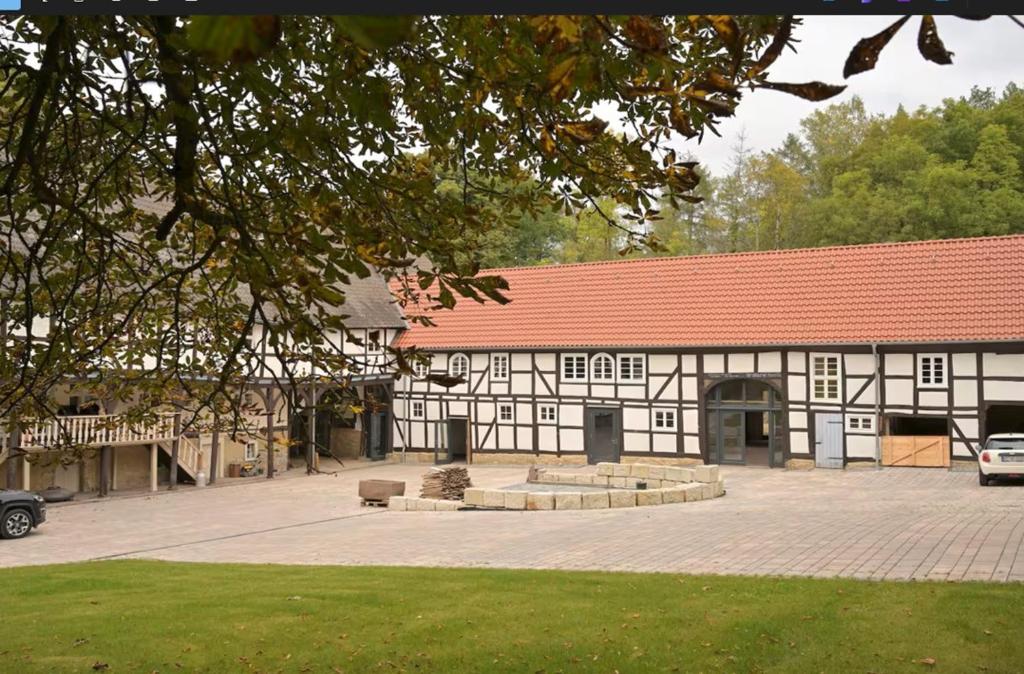 a black and white building with a red roof at Gut Junkernhof in Calden