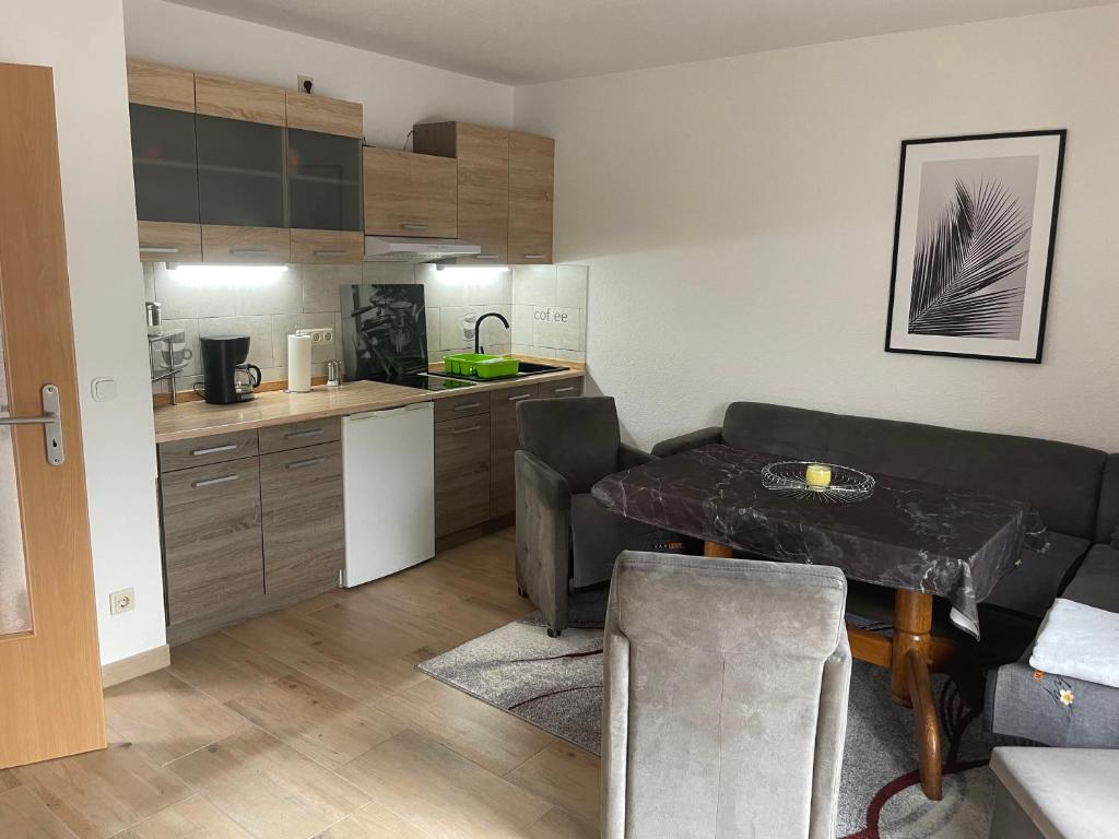 a kitchen with a table and a couch in a room at Haus Sonnenschein in Koserow