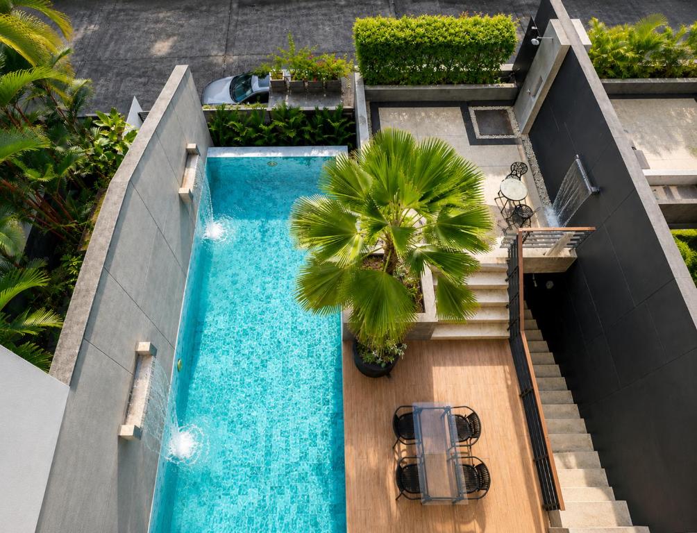 an overhead view of a swimming pool with a palm tree at Luxury Villa with Panoramic Seaview, Private Pool in Ban Saiyuan (1)