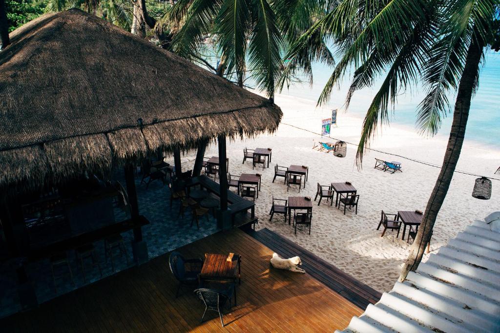 an aerial view of a beach with tables and chairs at Sand in My Shoes Beach Loft in Thong Nai Pan Noi