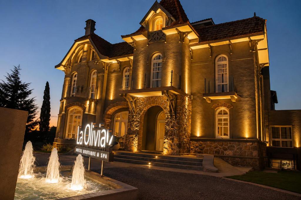 an old building with a sign in front of it at La Olivia Hotel Boutique & Spa in La Falda