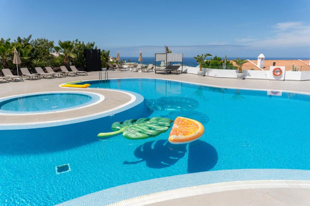 a swimming pool with an orange in the middle at Costa Adeje Garden Aparthotel in Adeje
