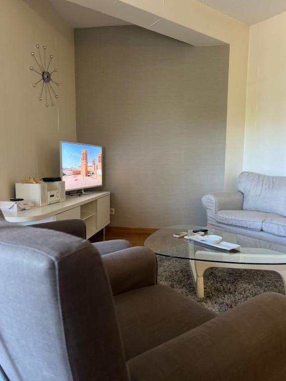 a living room with two couches and a tv at Bar Luxury Apartment in Bar