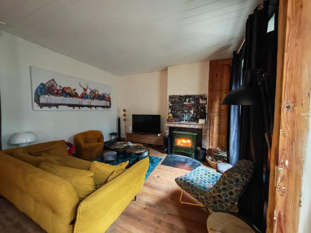 a living room with a couch and a fireplace at Chez Mina in Saint-Béat