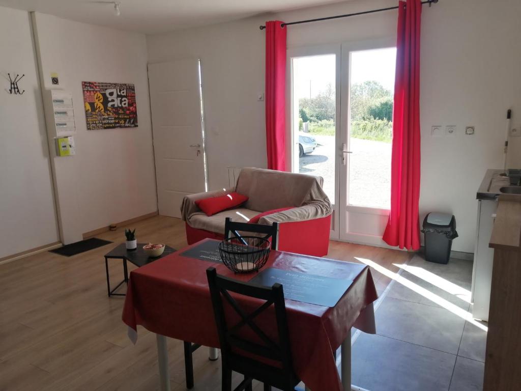 a living room with a table and a couch at Marina & Alex in Château-Gaillard