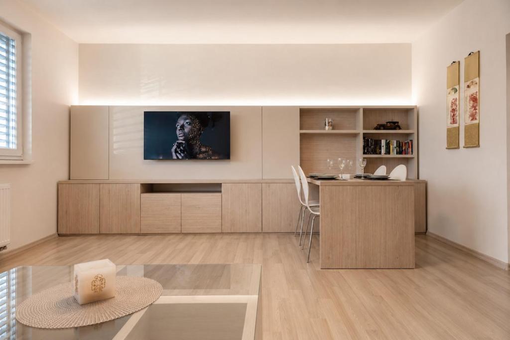 a living room with a television and a table at Apartman Pred polom in Trenčín