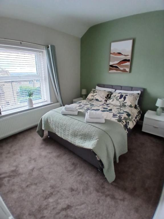 a bedroom with a bed and a large window at Hilltop Retreat at Banktop in Southowram