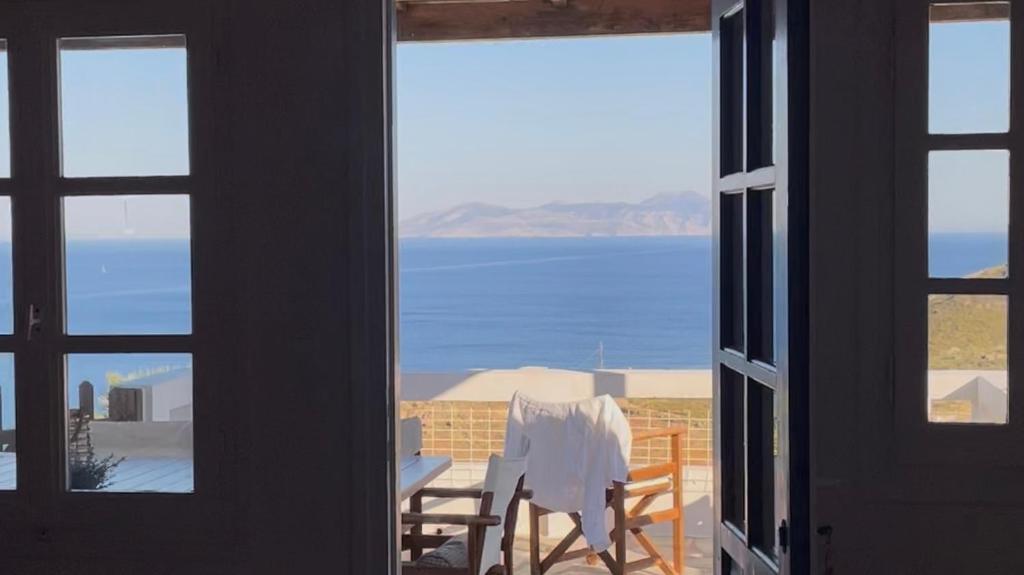 a room with a view of the ocean from a window at Chez Semiramis The Sun Touch House for 8 persons 5'min from the beach in Rámos