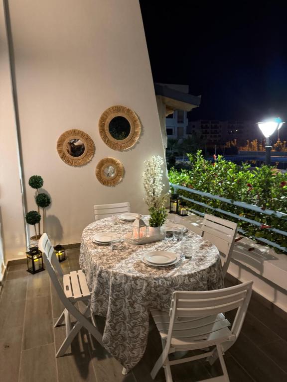 a table and chairs on a patio at night at smir park Mdiq in M'diq
